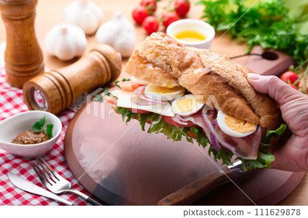 Baguette sandwich with plenty of toppings Baguette sandwich with plenty of toppings 111629878