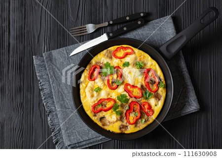 omelette with vegetables in a pan, top view 111630908