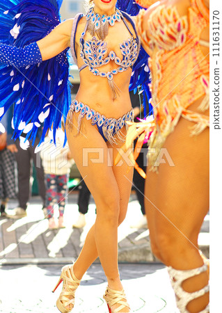 Brazilian costumes dancing samba on the streets of the city 111631170