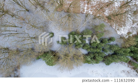 Winter's Lace: Aerial Patchwork of Snow and Evergreens 111632090