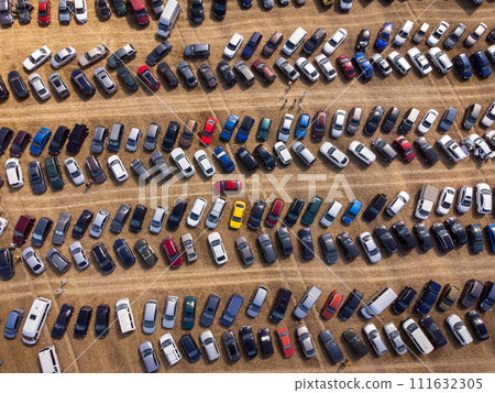 Aerial view of crowded parking lot with various colored cars Aerial view of crowded parking lot with various colored cars 111632305
