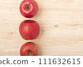 bright red apples placed on the table 111632615
