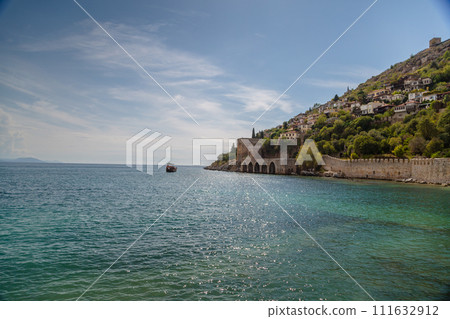 Beautiful sandy beach and soft turqoise Mediterranean sea wave - Landscape of ancient shipyard near of Kizil Kule tower - Alanya peninsula, Turkey 111632912