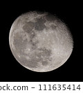 An almost full moon shining in the autumn night sky 111635414