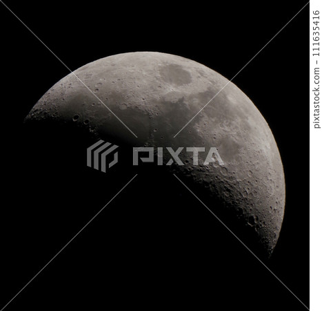 A waxing moon floating in the late autumn night sky 111635416