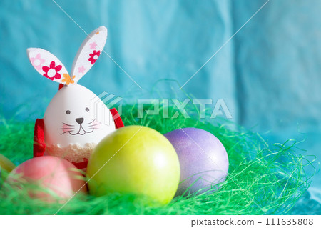 Colorful Easter eggs, green nest and bunny rabbit Colorful Easter eggs, green nest and bunny rabbit 111635808