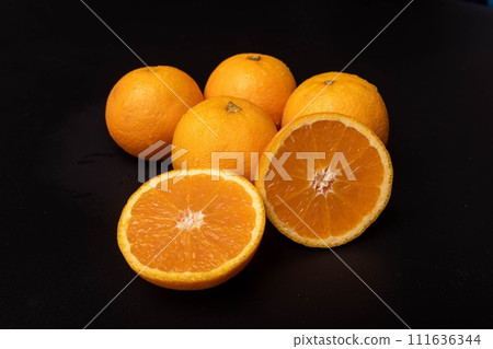 Fresh oranges on black background Fresh oranges on black background 111636344