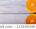 A cut orange photographed from an overhead view 111636346