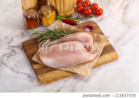 Raw chicken breast served rosemary 111637350
