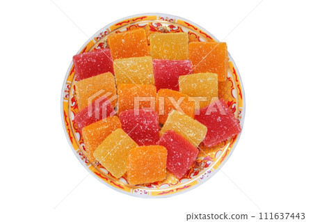 Marmalade candy in a plate isolated on white background. Sweet fruity desserts in plate for the holiday. Top view. Marmalade candy in a plate isolated on white background. Sweet fruity desserts in plate for the holiday. Top view. 111637443