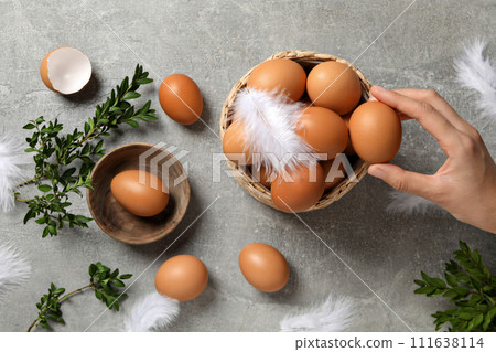 Eggs in a wicker basket, on a gray background. Eggs in a wicker basket, on a gray background. 111638114