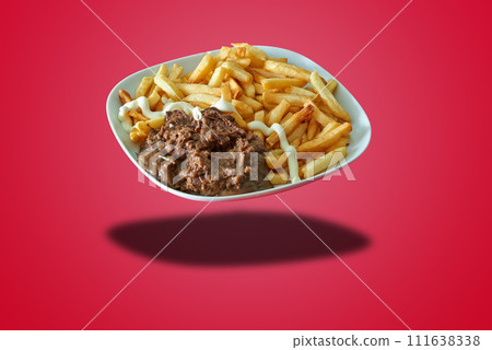 Floating plate with Flamish stew and french fries on red gradient Floating plate with Flamish stew and french fries on red gradient 111638338