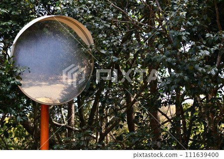 Curved mirror installed on a mountain road with poor visibility 111639400