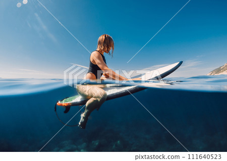 Surfer girl in hot bikini on surfboard. Water sport lifestyle and summer vacation 111640523