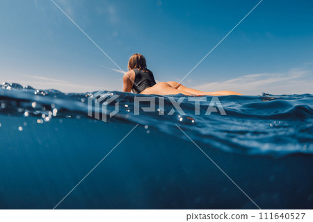Beauty surfing girl in sexy bikini with surfboard. Water sport lifestyle on summer vacation 111640527