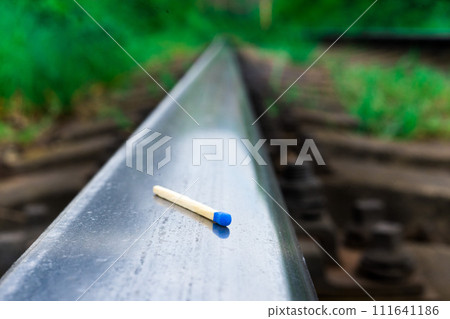 Matches on rails railroad tracks background, fire on railways concept 111641186