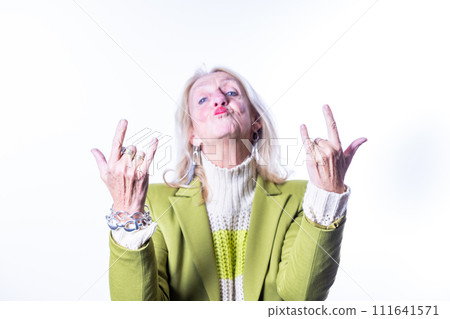 Playful Senior Woman Making Rock and Roll Hand Sign Playful Senior Woman Making Rock and Roll Hand Sign 111641571