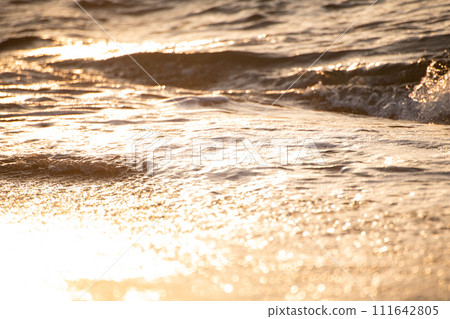 waves lit by the setting sun 111642805