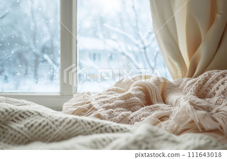 Portrait of a Bengal cat in a warm hat on a white background. 111643018