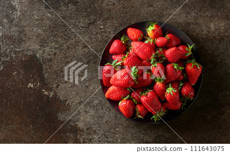 Fresh juicy strawberries on a stone background. Fresh juicy strawberries on a stone background. 111643075