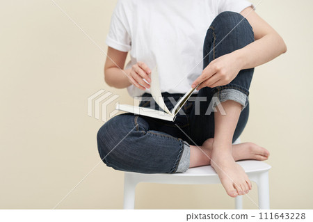 The young woman is holding book 111643228