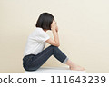 A woman sitting and taking pictures 111643239