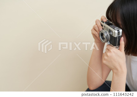 A woman sitting and taking pictures 111643242