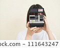 A woman sitting and taking pictures 111643247