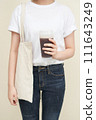 The young woman is holding coffee 111643249