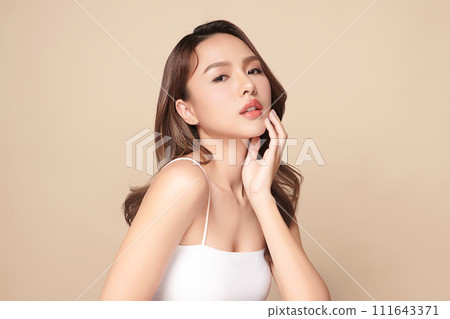 Beautiful young asian woman with clean fresh skin on beige background, Face care, Facial treatment, Cosmetology, beauty and spa, Asian women portrait. 111643371