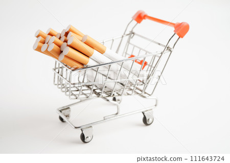Cigarette in shopping cart, cost, trading, marketing and production, No smoking concept. Cigarette in shopping cart, cost, trading, marketing and production, No smoking concept. 111643724