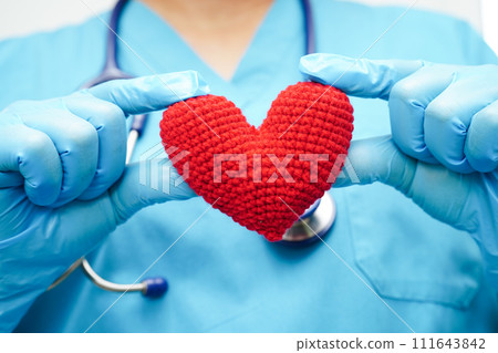 Asian woman doctor holding red heart for health in hospital. Asian woman doctor holding red heart for health in hospital. 111643842