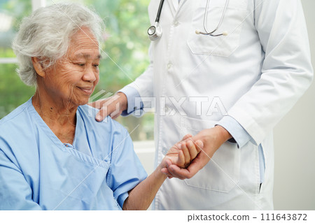 Doctor holding hands Asian elderly woman patient, help and care in hospital. Doctor holding hands Asian elderly woman patient, help and care in hospital. 111643872
