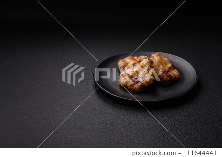 Round minced chicken or pork cutlet wrapped in bacon with salt, spices and herbs 111644441