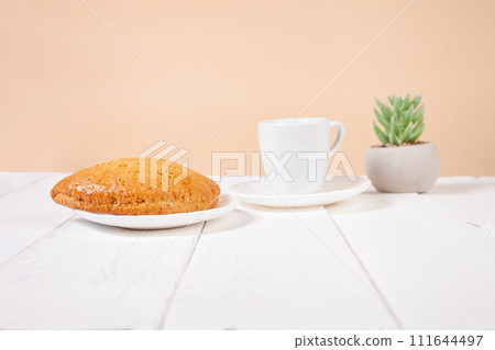 Minimalism, food on a background. Empty text space, mocap. Bun Tea Green beige white background. Ecological. 111644497