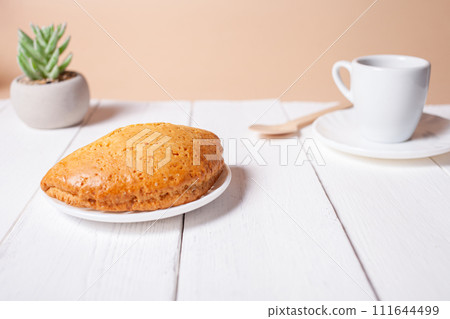 Minimalism, food on a background. Empty text space, mocap. Bun Tea Green beige white background. Ecological. Minimalism, food on a background. Empty text space, mocap. Bun Tea Green beige white background. Ecological. 111644499
