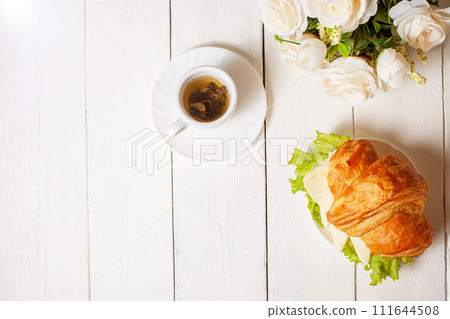 Minimalism, food on a background. Empty text space, mocap. Croissant with cheese sausage greens. 111644508