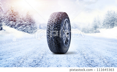 Winter tire on road covered with snow 111645363