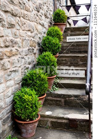Wonky Stone Steps With Warning Signs And Plants At Stone Cottage In Hay-On-Wye In Wales, United Kingdom Wonky Stone Steps With Warning Signs And Plants At Stone Cottage In Hay-On-Wye In Wales, United Kingdom 111646314