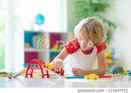 Child with toy train. Kids wooden railway. 111647351