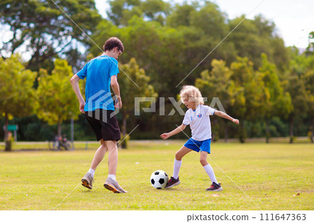 Kids play football. Child at soccer field. 111647363