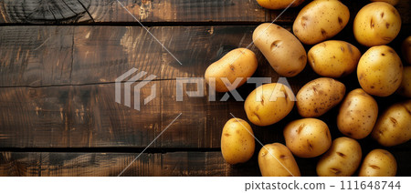 AI-generated content. Freshly harvested yellow potatoes scattered on a dark wooden surface, with a text-friendly area on the left, suitable for topics on organic produce and cooking. 111648744