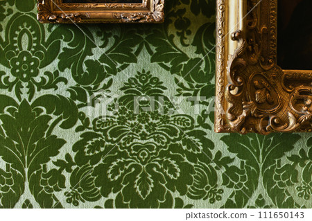 Green velvet wallpaper and gold frames with paintings 111650143
