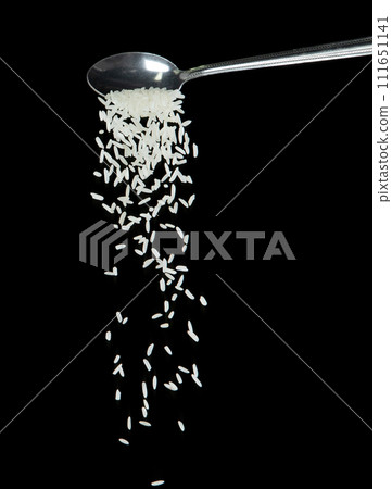 Japanese Rice fall, white grain rices pouring down abstract cloud fly from spoon. Beautiful complete seed rice in air, food object design. Selective focus freeze shot Black background isolated 111651141