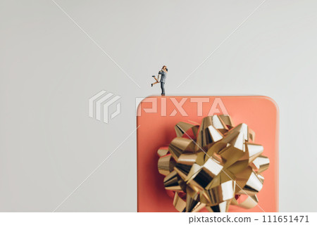 Couple hugging on a giant gift box Couple hugging on a giant gift box 111651471