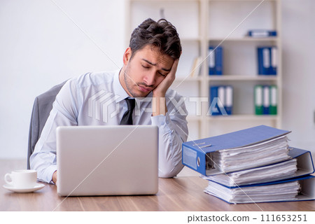 Young male employee working in the office Young male employee working in the office 111653251