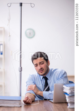 Young male employee suffering at workplace 111653350