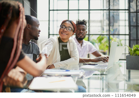 Diverse group of smiling businesspeople talking together around Diverse group of smiling businesspeople talking together around 111654049