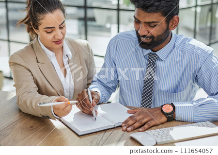 Young account manager advisor lawyer showing paper documents to partner 111654057