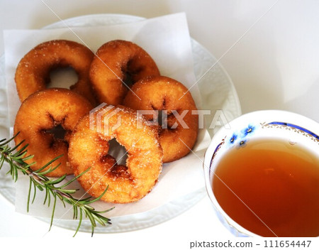 Donuts and tea on a plate, tea time Donuts and tea on a plate, tea time 111654447